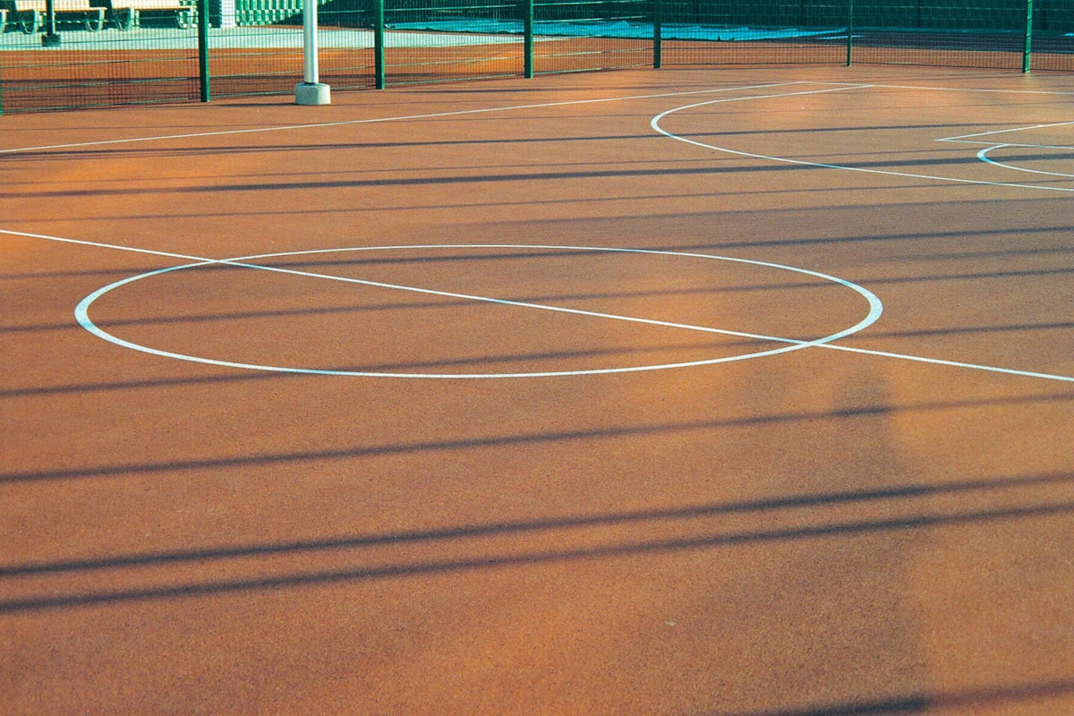 Sport court surface coated and striped with fresh white playing lines
