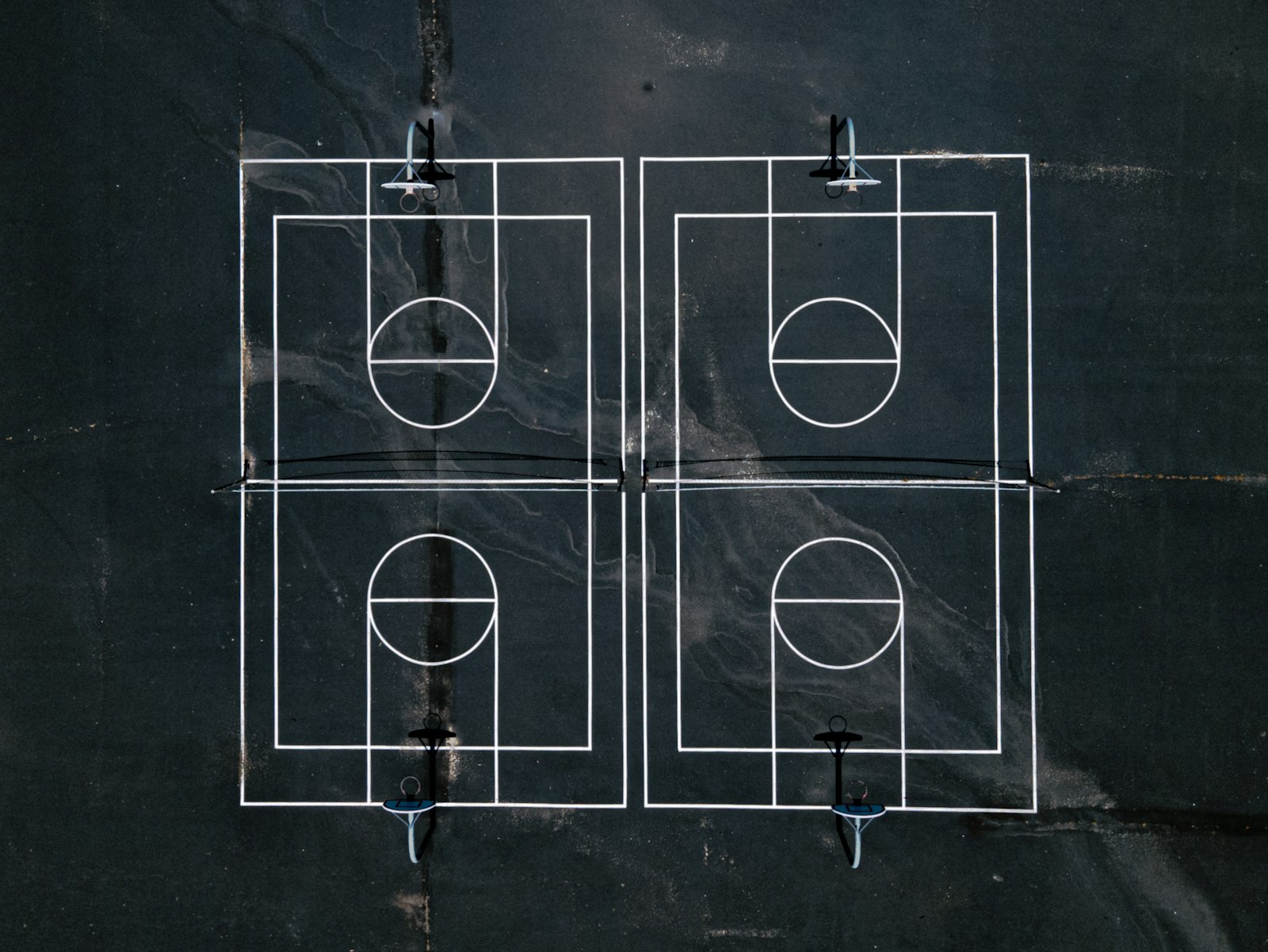 Drone shot of a pickleball court layout with net, kitchen and service courts