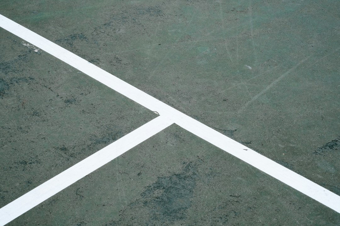 Freshly painted white pickleball court lines with crisp contrast