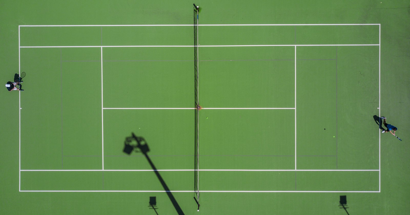 High angle view of a sports court layout showing the net and kitchen non-volley zone