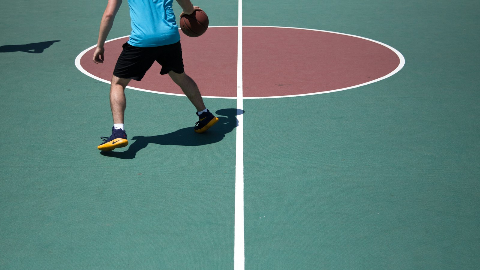 Outdoor multi-sport court surface with acrylic coating and proper drainage
