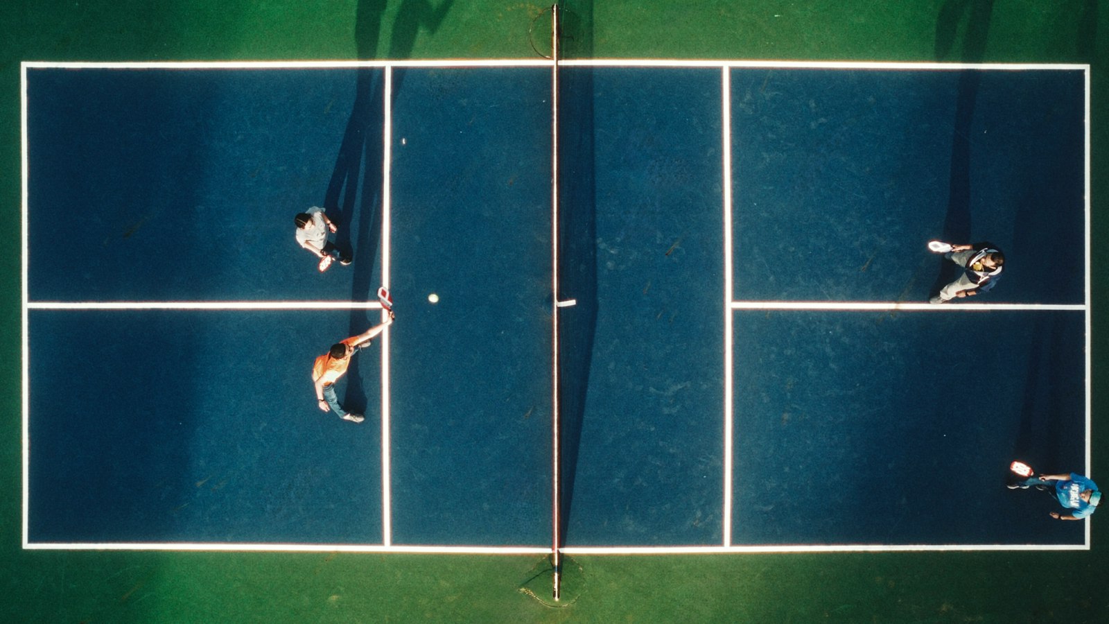 Aerial view of a pickleball court showing its non-volley zone kitchen and compact size