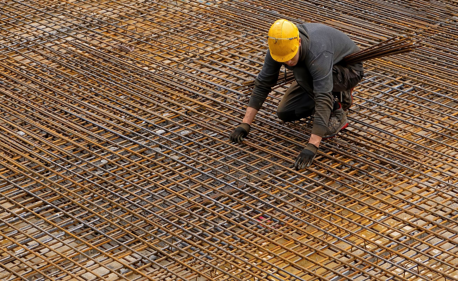 Construction crew building the concrete base for a sports court