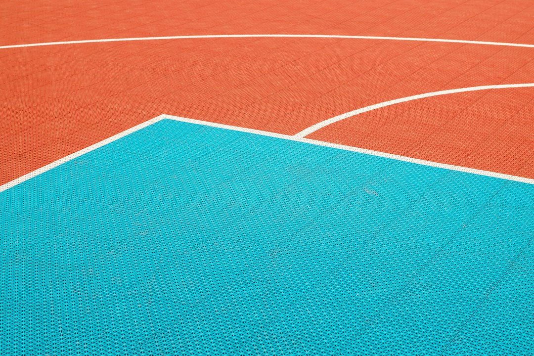 Vibrant blue and green outdoor pickleball court surface color detail
